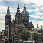 Stunning view of Basilica of Saint Nicholas in Amsterdam with a vibrant blue sky backdrop.
