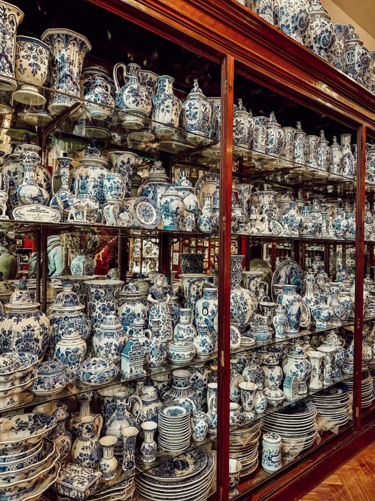 A large collection of intricate blue and white porcelain in a display cabinet.