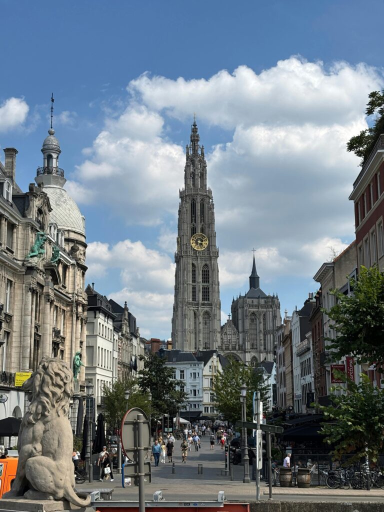 Skyline view of Antwerp featuring the iconic Cathedral of Our Lady under a vibrant sky.