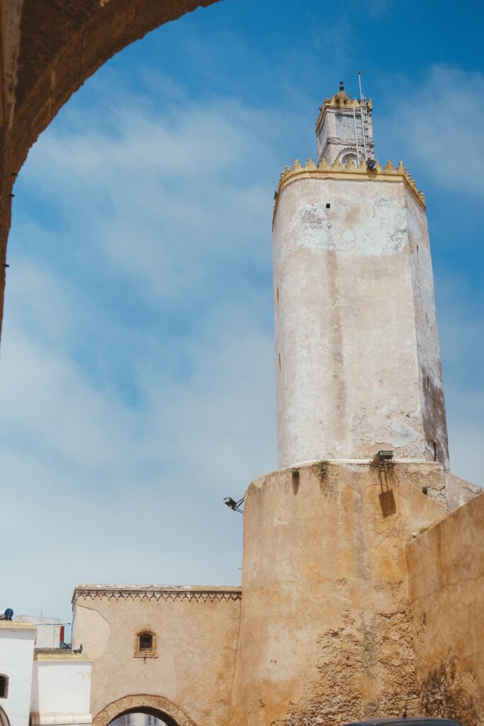 Stunning view of the historic tower in El Jadida, Morocco, under a clear blue sky.