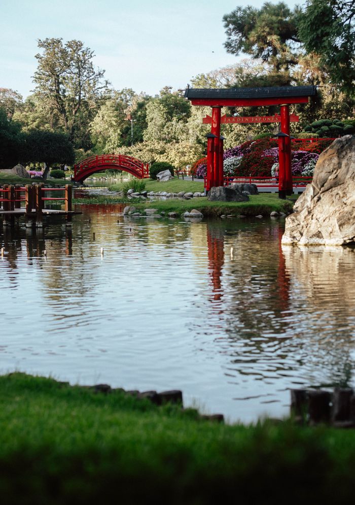 Peaceful Japanese garden with iconic red torii gate and bridge in Buenos Aires.