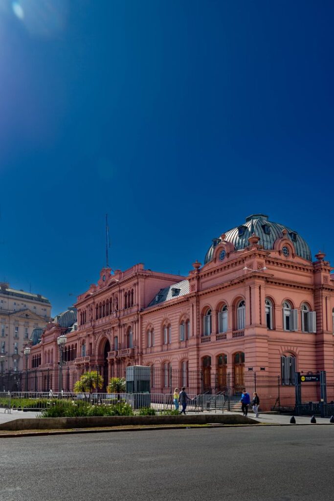 The iconic pink Casa Rosada in Buenos Aires under a clear blue sky.